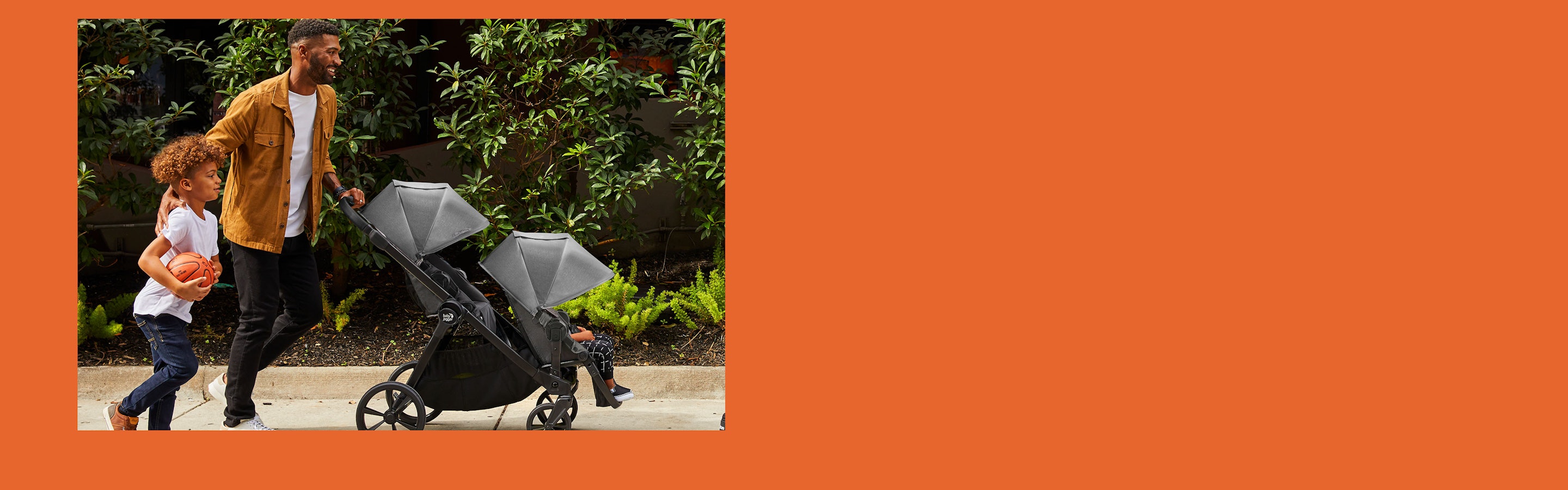 family pushing stroller banner